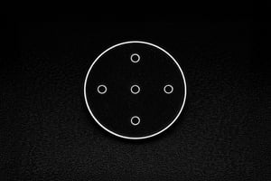 Transparent custom sapphire part used as an optical window, featuring multiple micro-drilled holes on a black background.