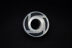 Internal macro view of a cylindrical custom sapphire part with central bore and structural supports, showing internal geometry.