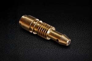 Threaded brass nozzle with fine machining and micro outlet, featuring an integrated custom sapphire part at the tip.